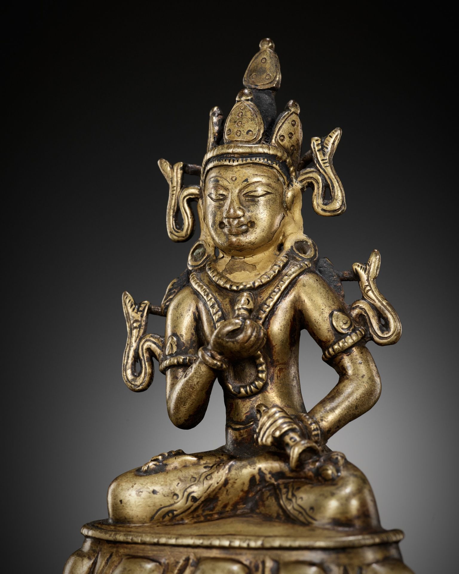 A GILT-BRONZE AND TURQUOISE-INLAID FIGURE OF VAJRASATTVA, KASHMIR STYLE, WEST TIBET, 12TH CENTURY