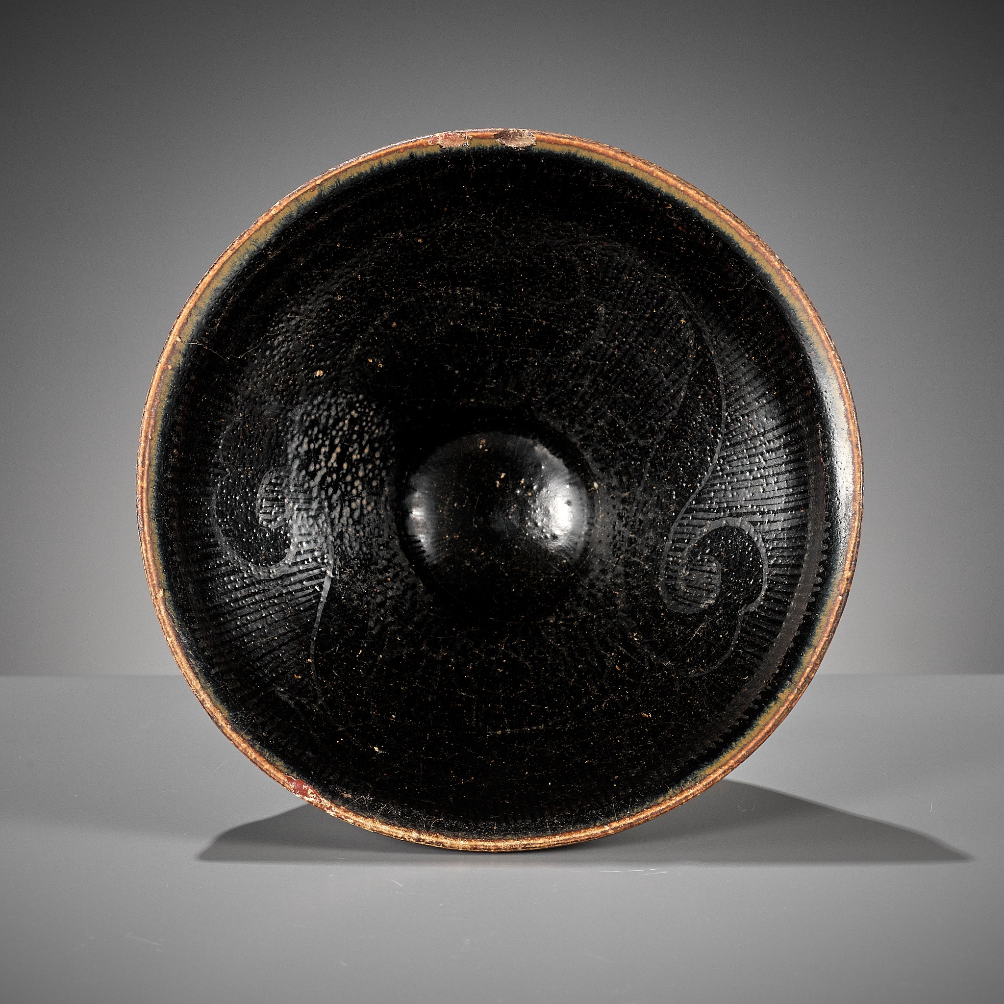 A CIZHOU SILVER-DECORATED AND BLACK-GLAZED TEA BOWL, SOUTHERN SONG OR JIN DYNASTY