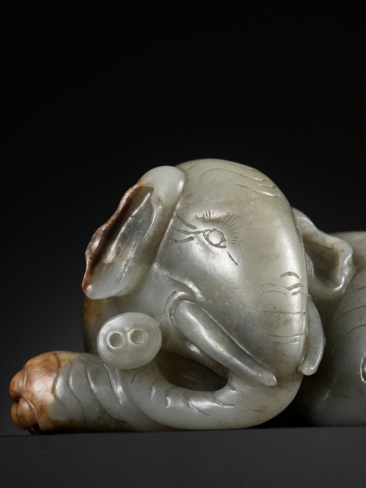 A GRAY AND RUSSET JADE FIGURE OF A RECUMBENT ELEPHANT, LATE MING TO MID-QING DYNASTY - Image 6 of 15
