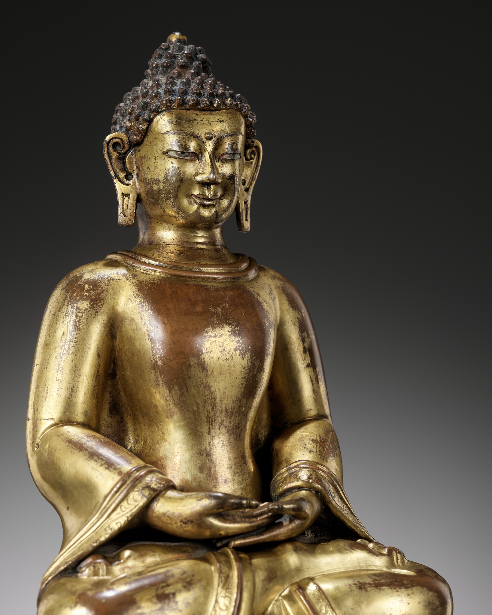 A GILT COPPER-ALLOY REPOUSSE FIGURE OF BUDDHA AMITABHA, WITH AN INSCRIPTION REFERRING TO THE SECOND