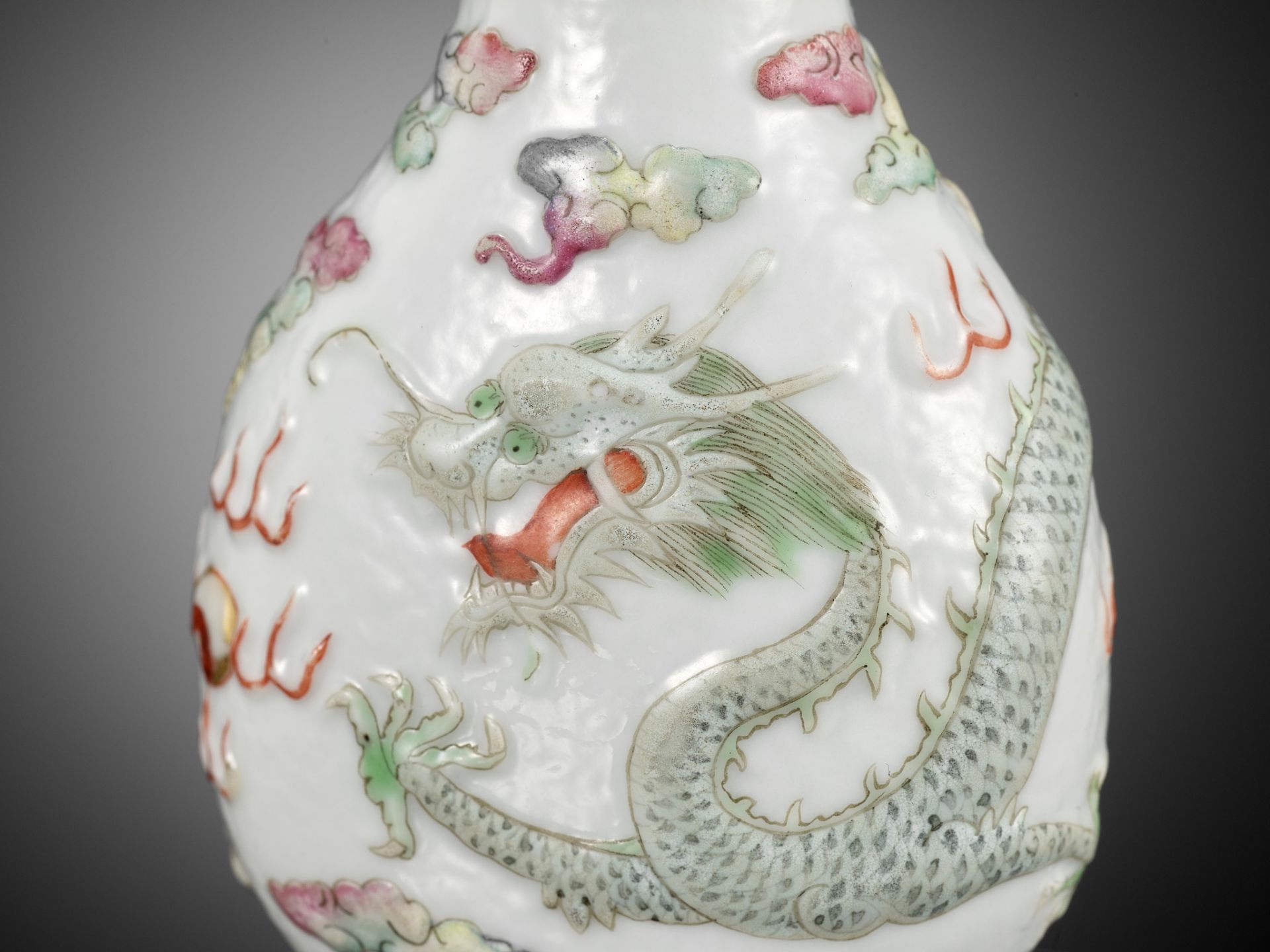 A MOLDED AND CARVED 'DRAGON' FAMILLE ROSE PORCELAIN SNUFF BOTTLE, SIGNED LIQUAN, CHINA, 1853-1864