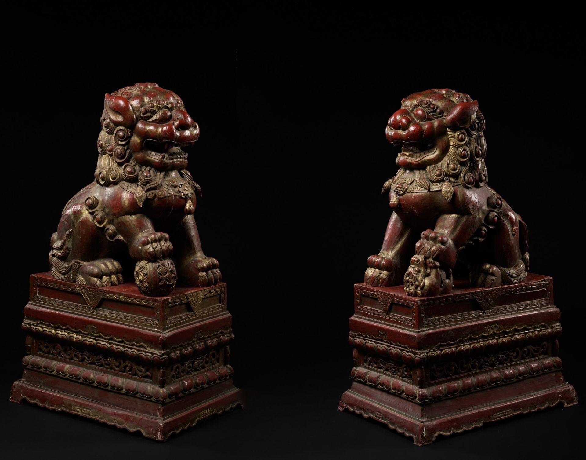 A PAIR OF MONUMENTAL GILT AND RED LACQUERED WOOD FIGURES OF BUDDHIST LIONS, LATE QING DYNASTY