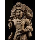 A LIMESTONE FIGURE OF THE THREE-HEADED VAIKUNTHA VISHNU, HINDU SHAHI