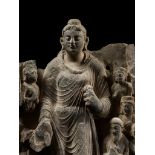 A LARGE GRAY SCHIST RELIEF DEPICTING BUDDHA, A ROYAL DONOR AND SEVERAL ATTENDANTS, ANCIENT REGION OF