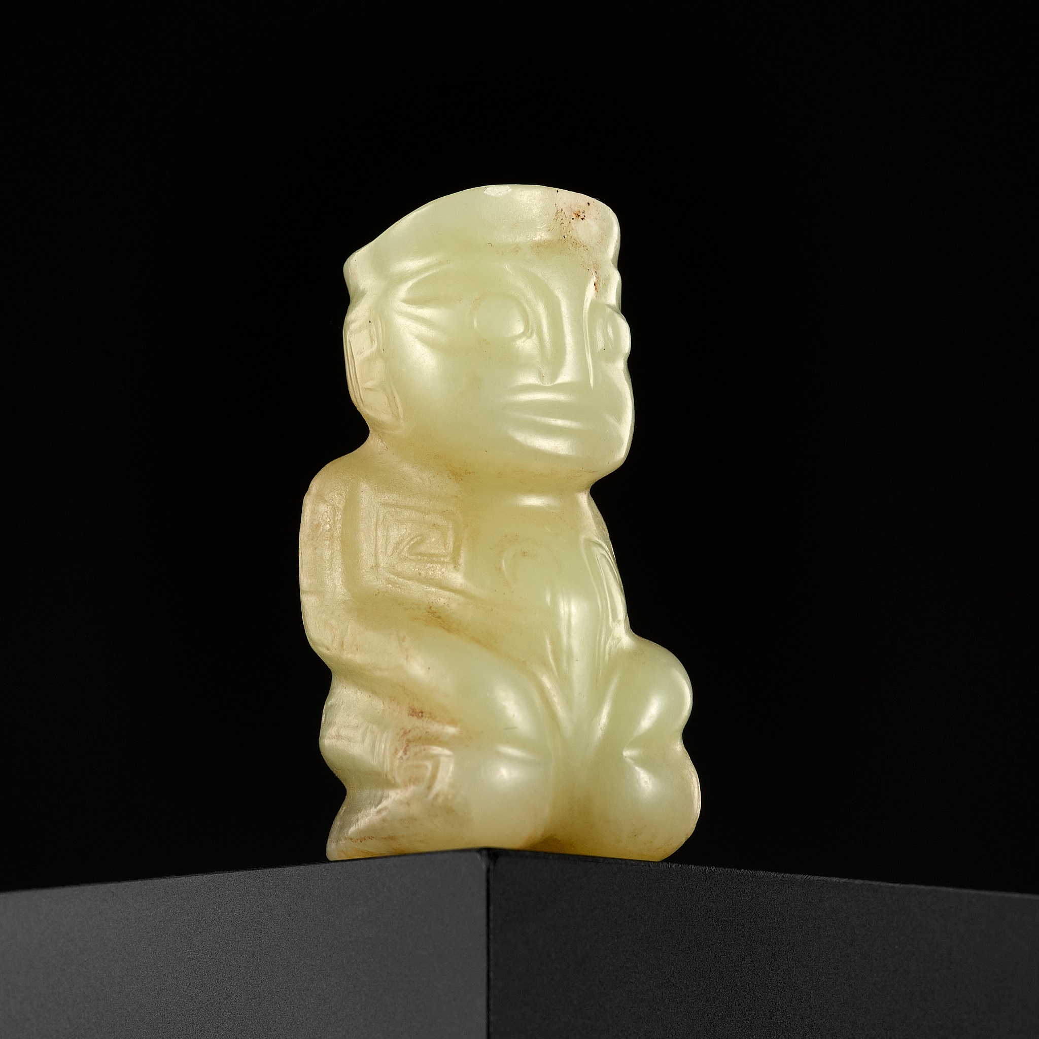 AN EXTREMELY RARE YELLOW JADE 'KNEELING FIGURE', SHANG DYNASTY