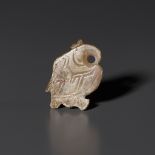 A PALE CELADON AND RUSSET JADE 'BIRD' PENDANT, LATE SHANG DYNASTY