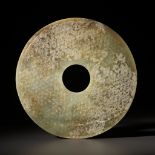 A CELADON AND BROWN JADE BI DISK, WESTERN HAN DYNASTY