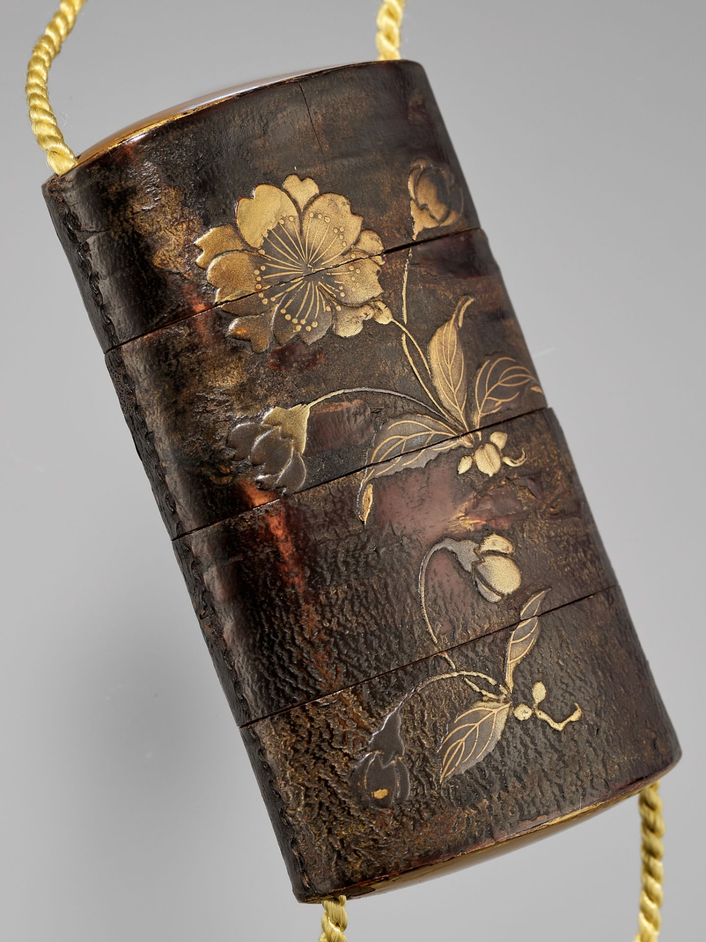 A RARE STITCHED CHERRY BARK THREE-CASE LACQUER INRO WITH CHERRY BLOSSOMS