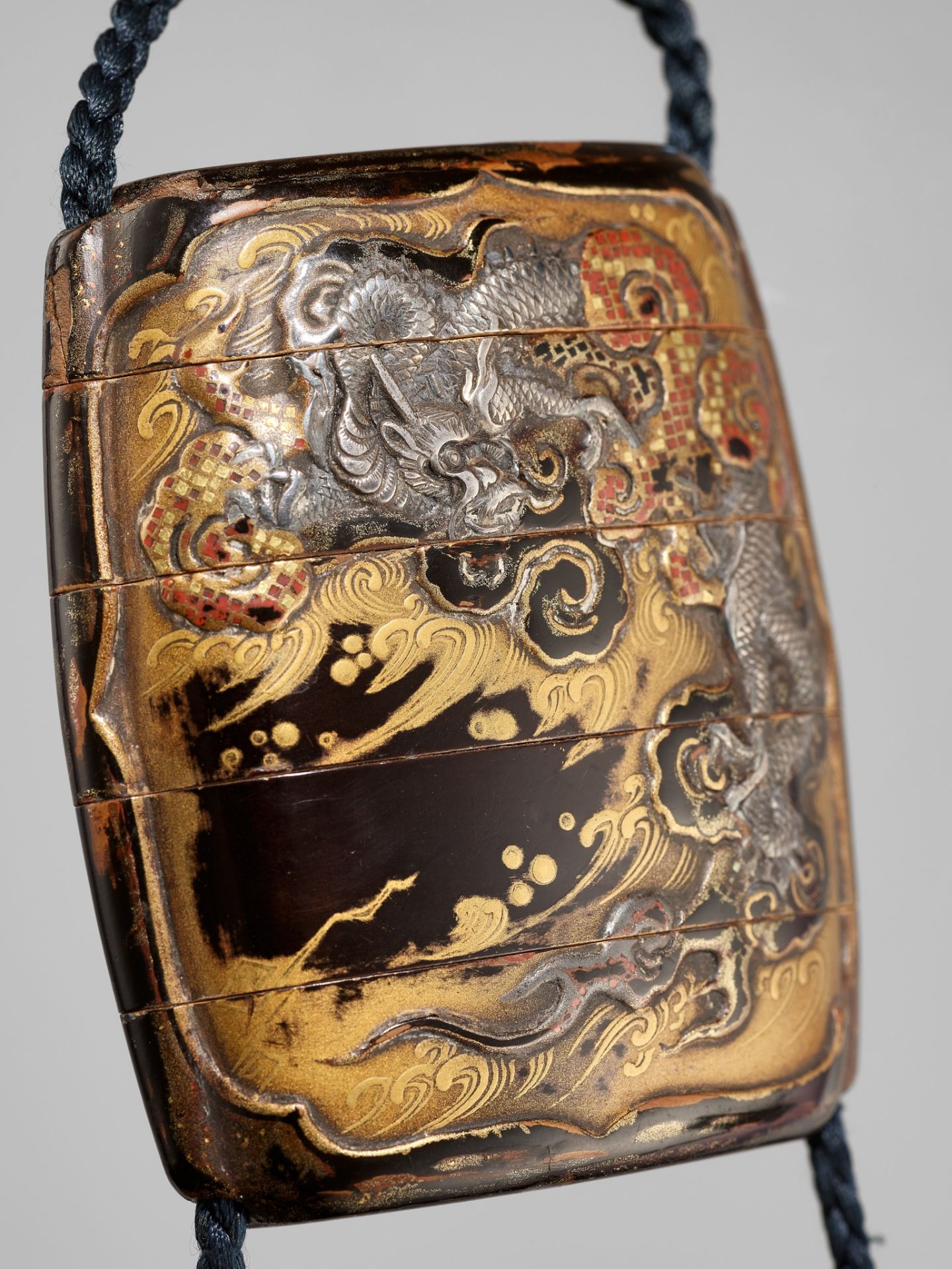A FINE SILVER-INLAID FOUR-CASE LACQUER INRO DEPICTING A TIGER AND DRAGON