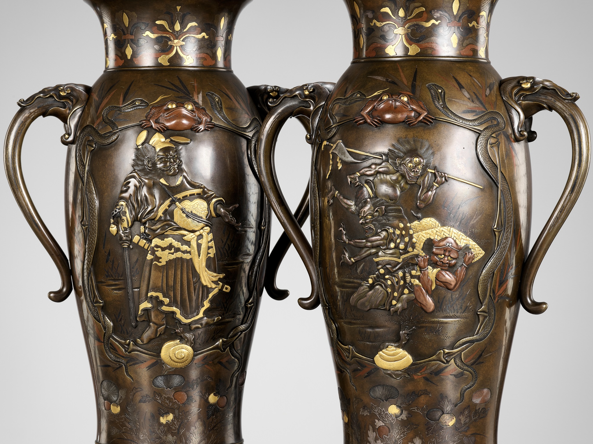 A SUPERB PAIR OF MIYAO-STYLE MIXED-METAL-INLAID AND PARCEL-GILT BRONZE VASES WITH SHOKI AND ONI