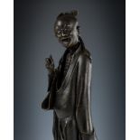 A BRONZE FIGURE OF AN IMMORTAL, LATE MING DYNASTY