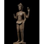 AN EXTREMELY RARE AND MONUMENTAL SANDSTONE STATUE OF VISHNU, ANGKOR PERIOD