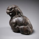 A BROWN LIMESTONE FIGURE OF A SEATED LION, TANG DYNASTY