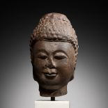 A LIMESTONE HEAD OF BUDDHA, TANG DYNASTY, CHINA, 7TH - EARLY 8TH CENTURY
