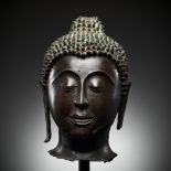 A LARGE BRONZE HEAD OF BUDDHA, SUKHOTHAI KINGDOM, THAILAND, 15TH CENTURY