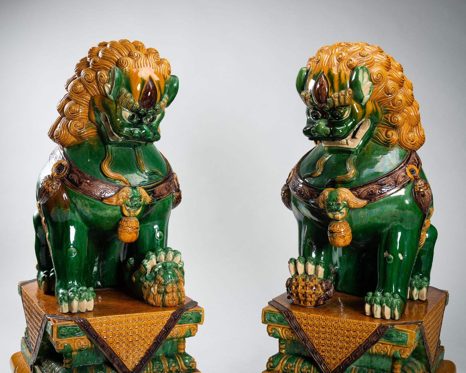 A VERY LARGE SANCAI-GLAZED PAIR OF BUDDHIST LIONS, QING