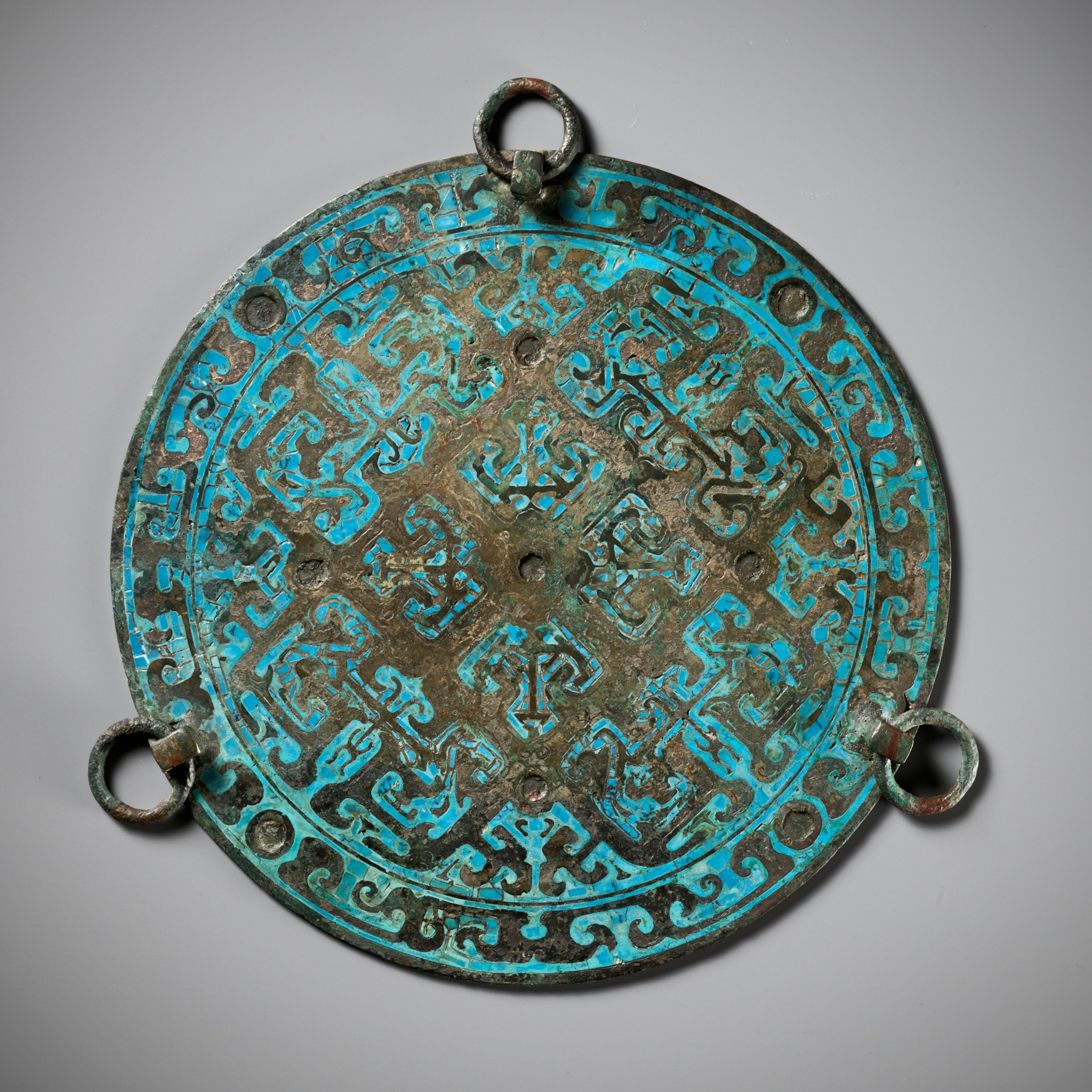 A RARE TURQUOISE-INLAID BRONZE MIRROR, WARRING STATES PERIOD