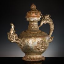 A MASSIVE SILVERED-COPPER RITUAL TEAPOT AND COVER, TIBET, 19TH CENTURY