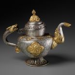 A PARCEL-GILT SILVER REPOUSSE RITUAL EWER