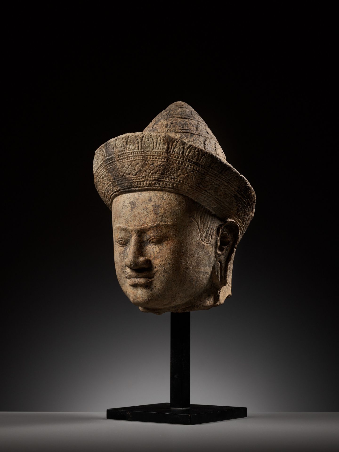 A LARGE SANDSTONE HEAD OF A MALE DEITY, ANGKOR PERIOD, KHLEANG STYLE - Image 2 of 11