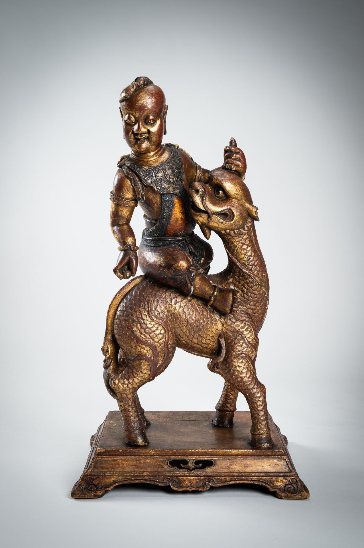A VERY LARGE GILT-LACQUERED WOOD STATUE OF YOUNG BUDDHA RIDING QILIN - Image 5 of 20