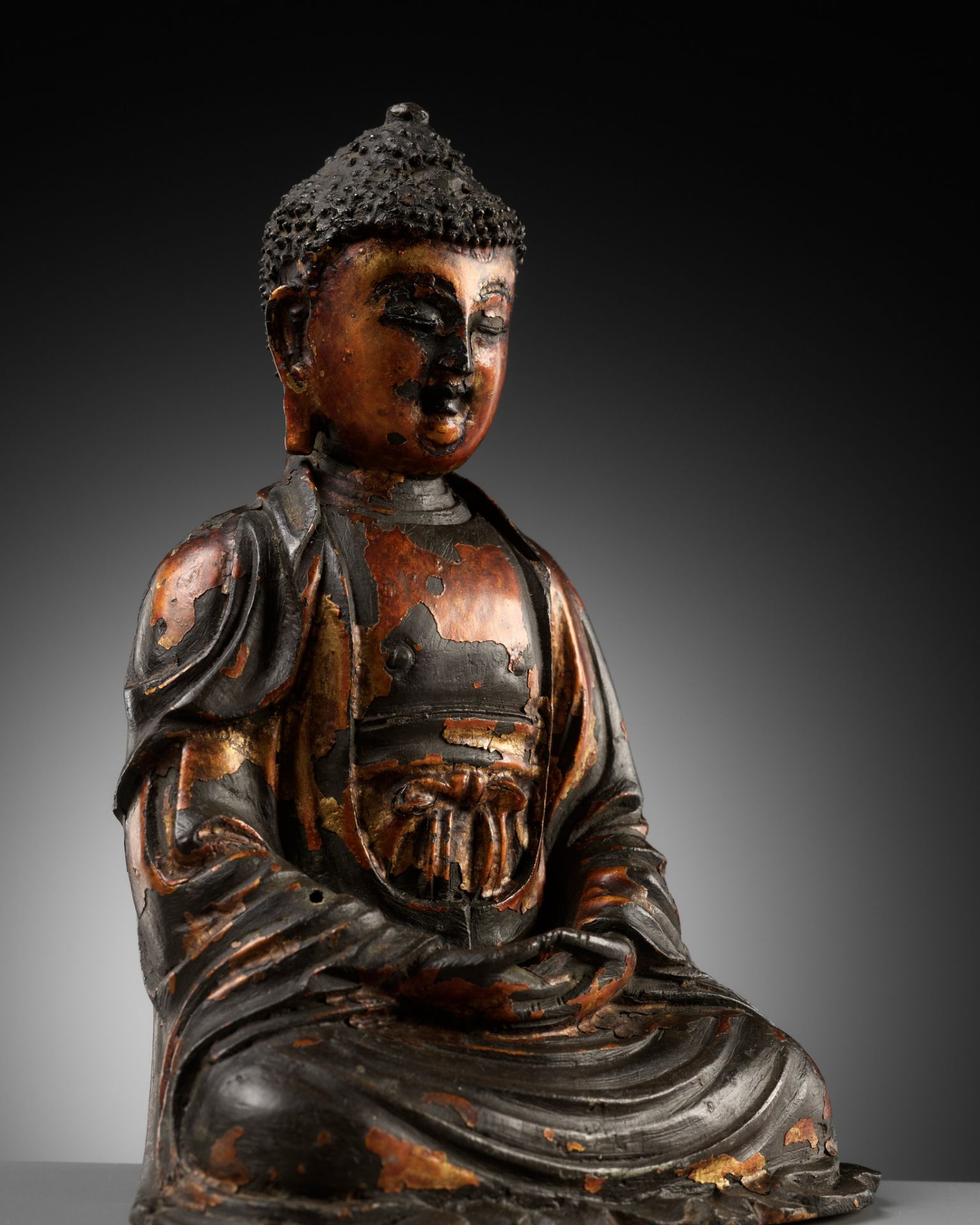 A GILT-LACQUERED BRONZE FIGURE OF BUDDHA, MING DYNASTY