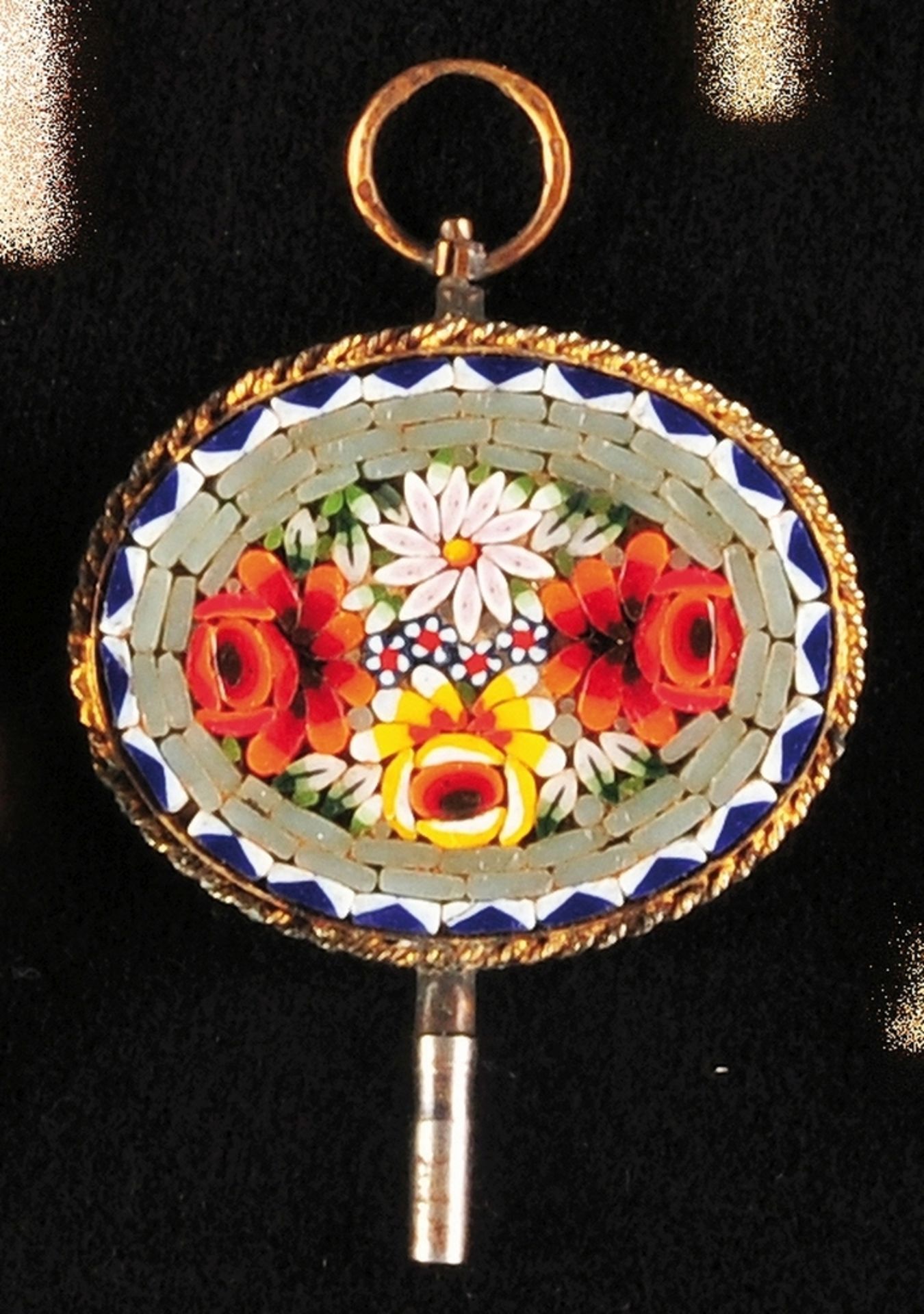 Mosaic pocket watch key in gilded setting, oval plate with colorful mosaic with flower decoration