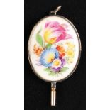 Pocket watch key, oval, porcelain, colorfully painted with floral decoration, in silver setting