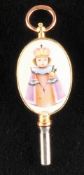 Golden pocket watch key with two painted porcelain medallions,