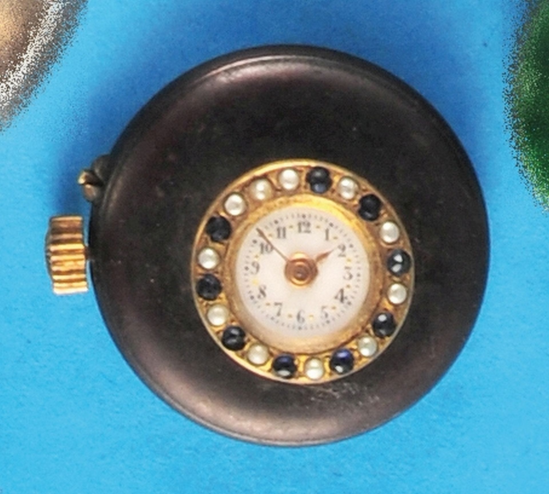 Buttonhole watch with gemstone bezel, burnished case, brass glass bezel