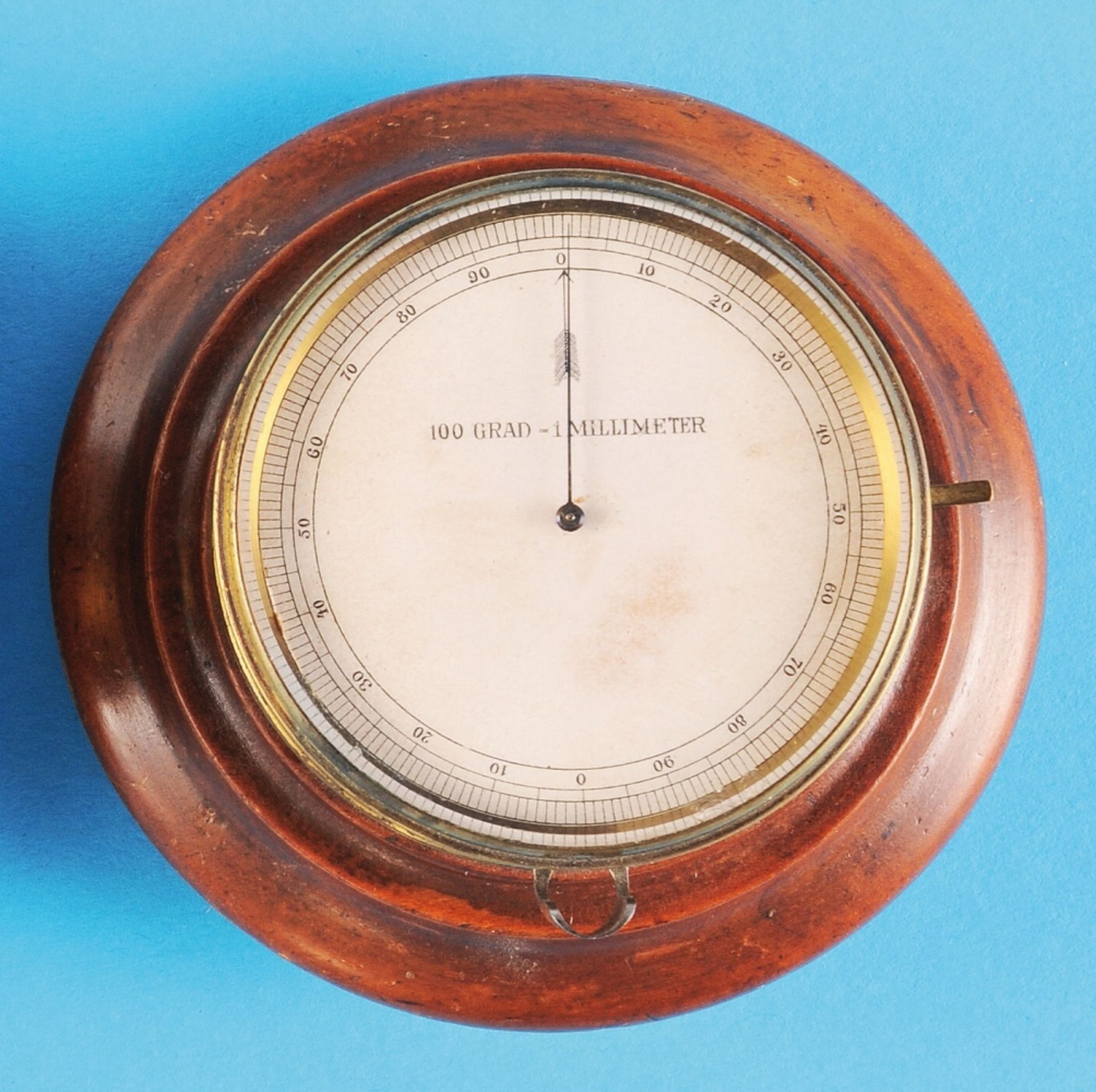 Micrometer in brass housing on round wooden base, 