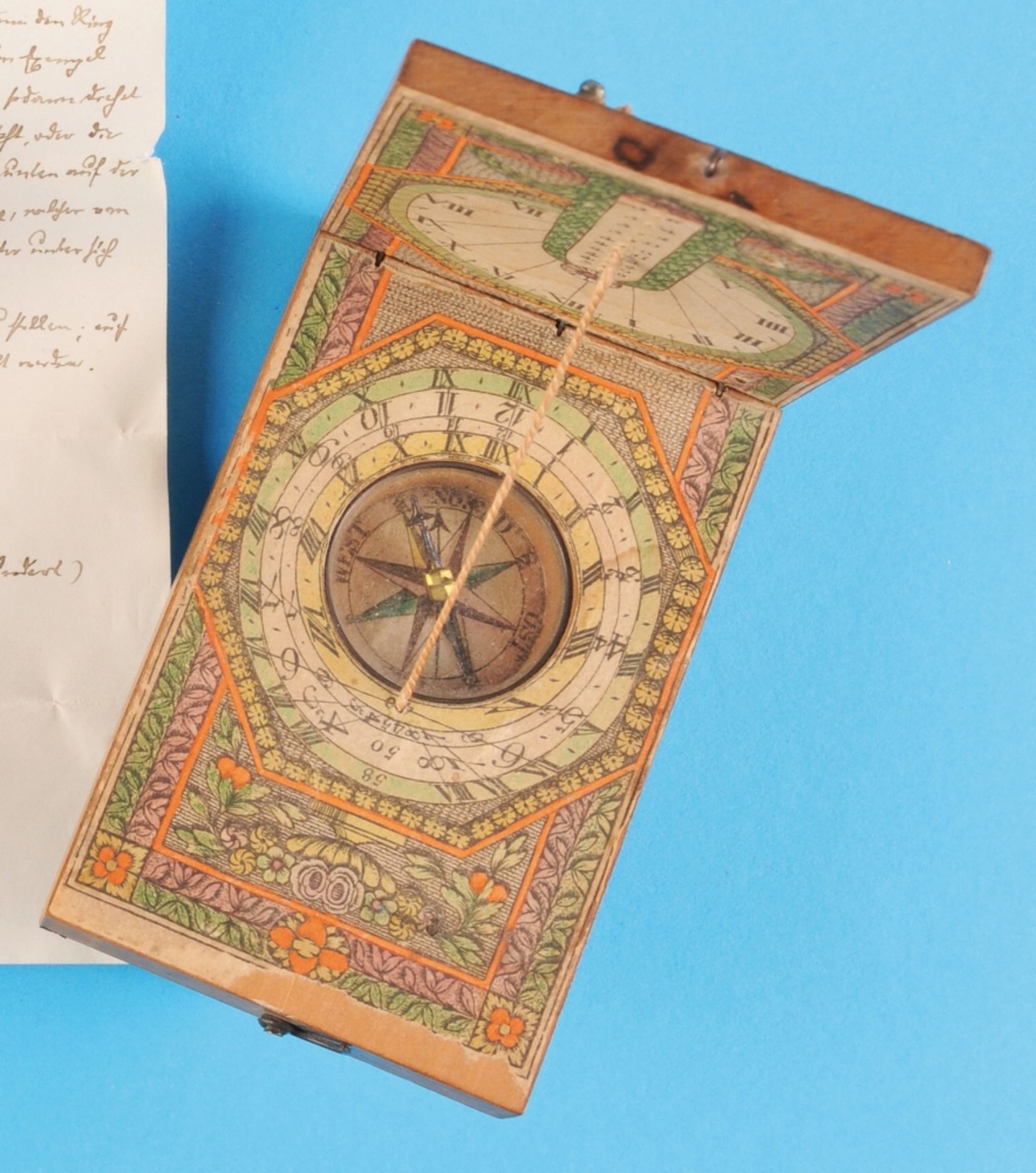 Rectangular wooden folding sundial, 18th century, with colorful paper cover,  