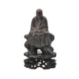 A CHINESE GUANGDONG STONEWARE FIGURE OF A SEATED IMMORTAL, QING DYNASTY, 19TH CENTURY
