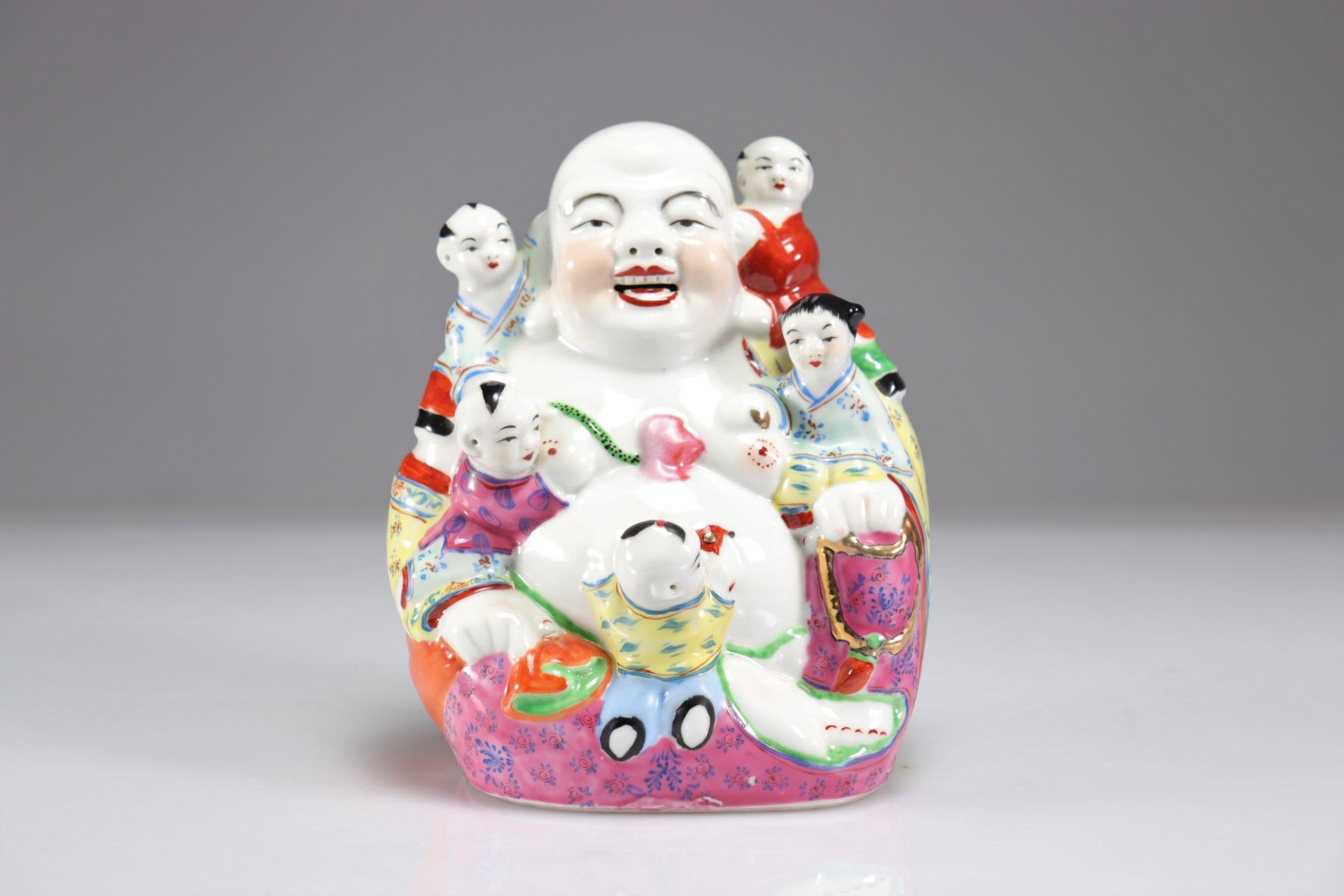 Buddha and children in famille rose porcelain