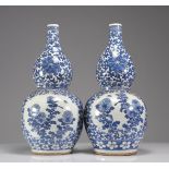 Pair of double-gourd vases in blue-white enamelled porcelain decorated with floriform medallions of