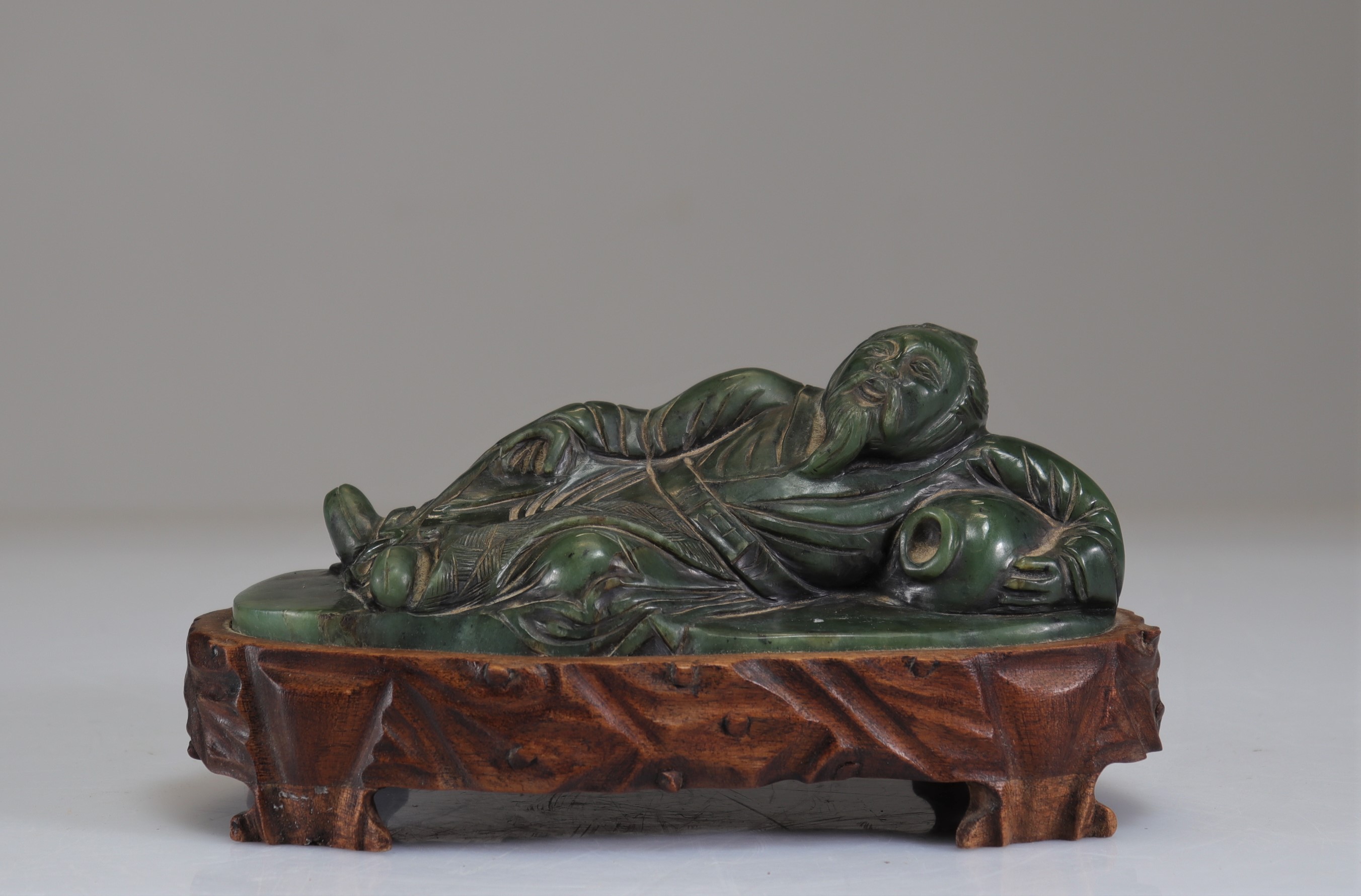 Qing period carved spinach jade reclining figure