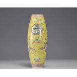 Famille rose vase decorated with dragons and phoenixes on a yellow background marked with circles