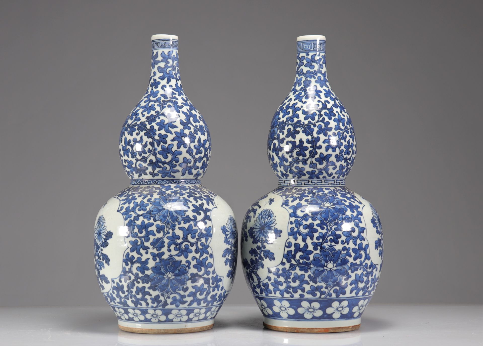 Pair of double-gourd vases in blue-white enamelled porcelain decorated with floriform medallions of - Image 2 of 5