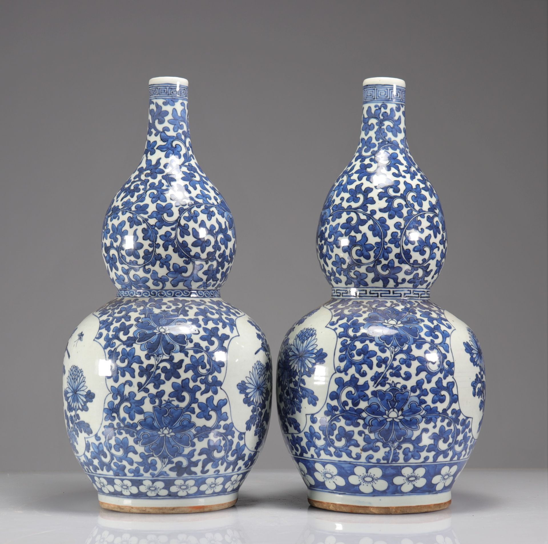 Pair of double-gourd vases in blue-white enamelled porcelain decorated with floriform medallions of - Image 4 of 5