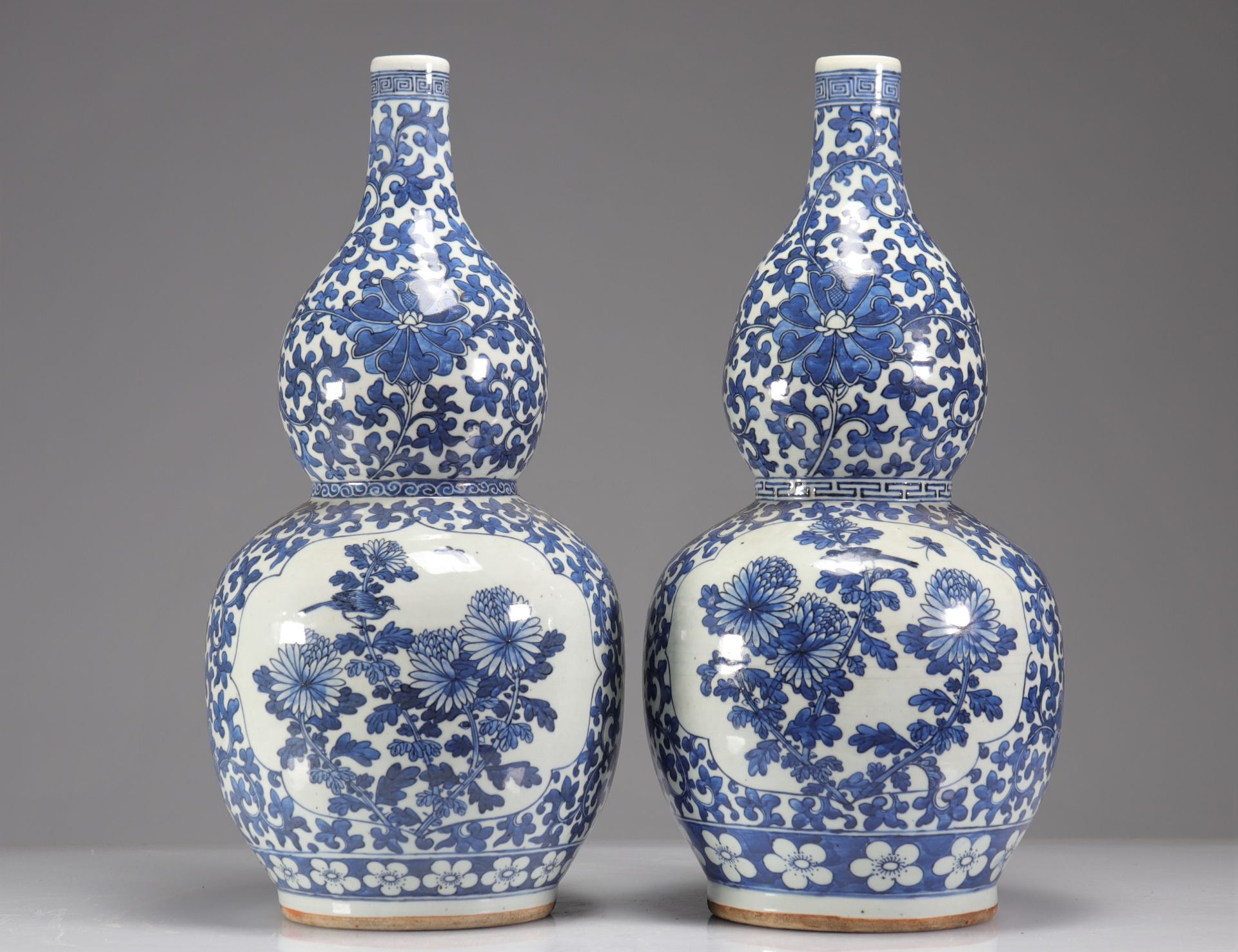 Pair of double-gourd vases in blue-white enamelled porcelain decorated with floriform medallions of - Image 3 of 5