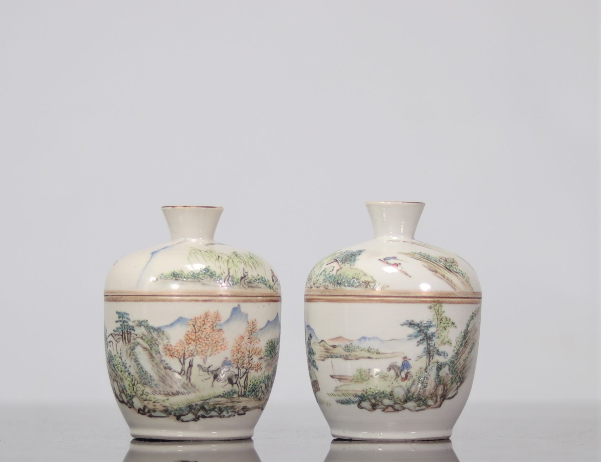 Pair of porcelain covered bowls decorated with landscape
