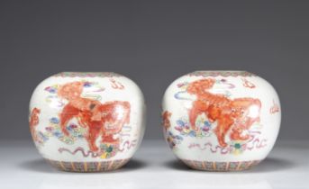 Pair of ball vases decorated with iron red lions