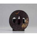 Japan Edo period (1603 - 1868). Steel tsuba in nagamarugata shape and embossed inlay of gilded and u