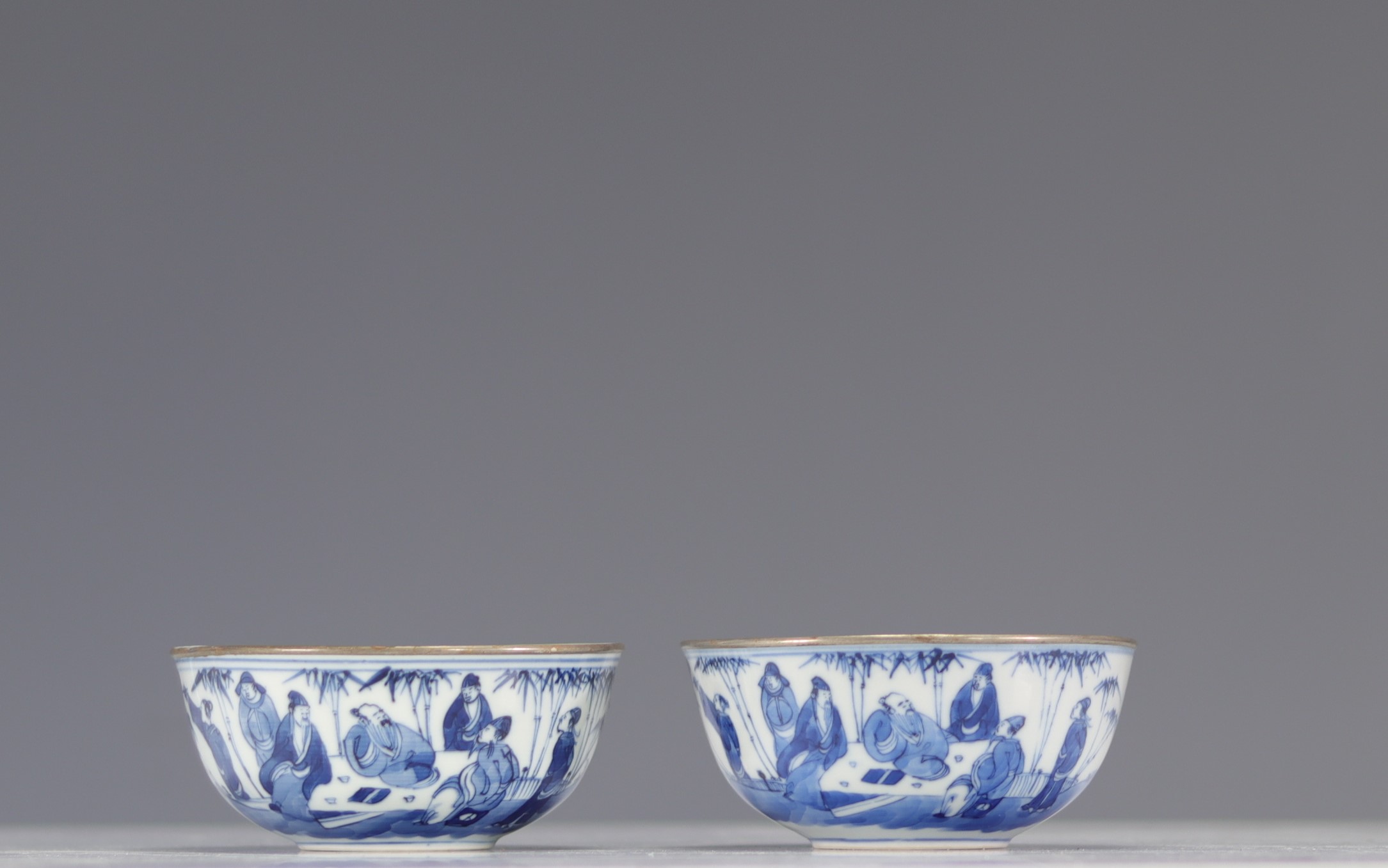 Pair of blue white bowls decorated with characters