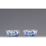 Pair of blue white bowls decorated with characters