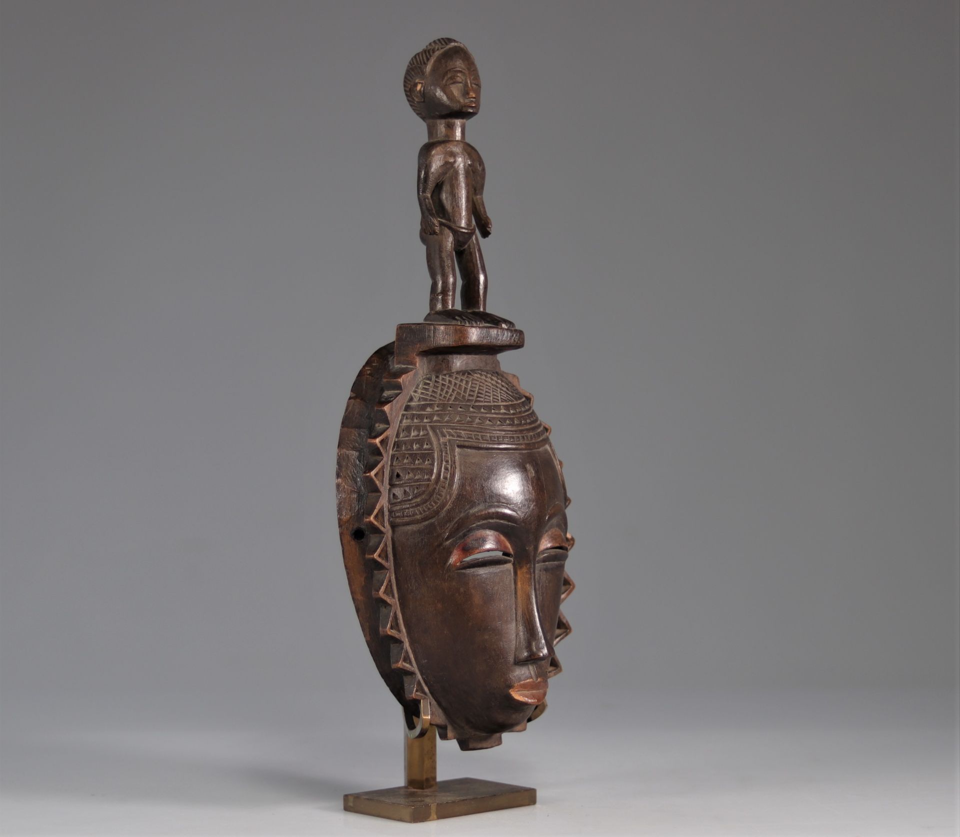 Baoule mask decorated with a character
