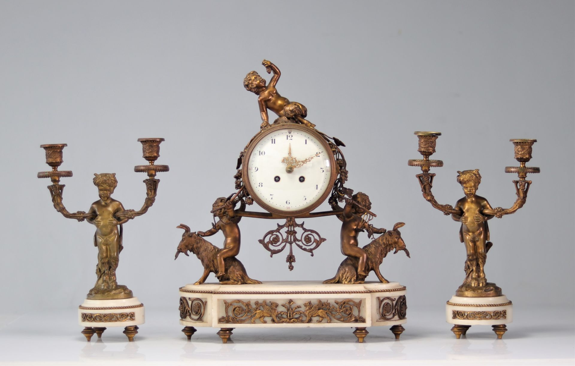 Pendulum set and Louis XVI bronze candlesticks decorated with fauns