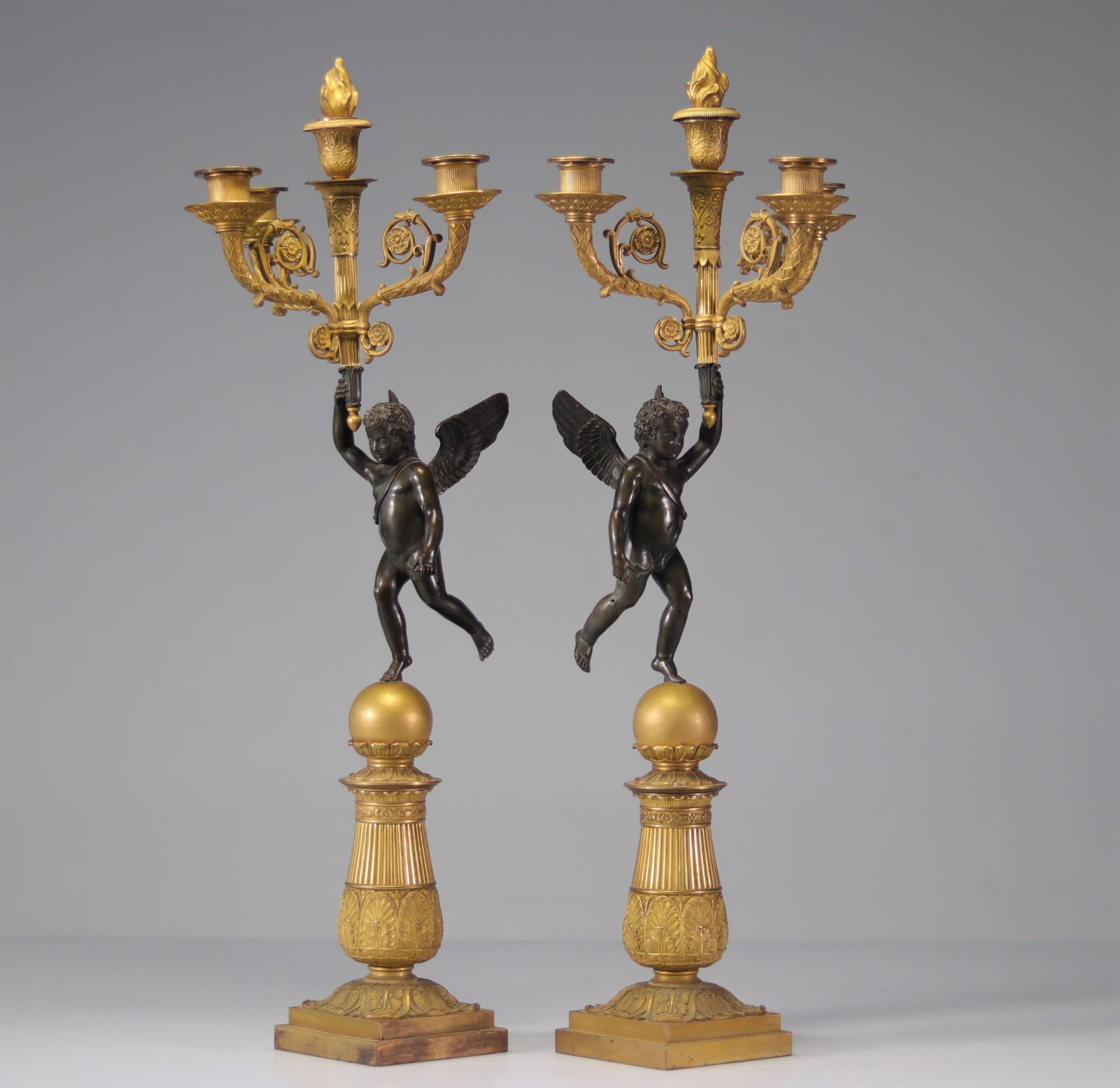 Pair of period Empire candelabras decorated with angels in bronze with two patinas