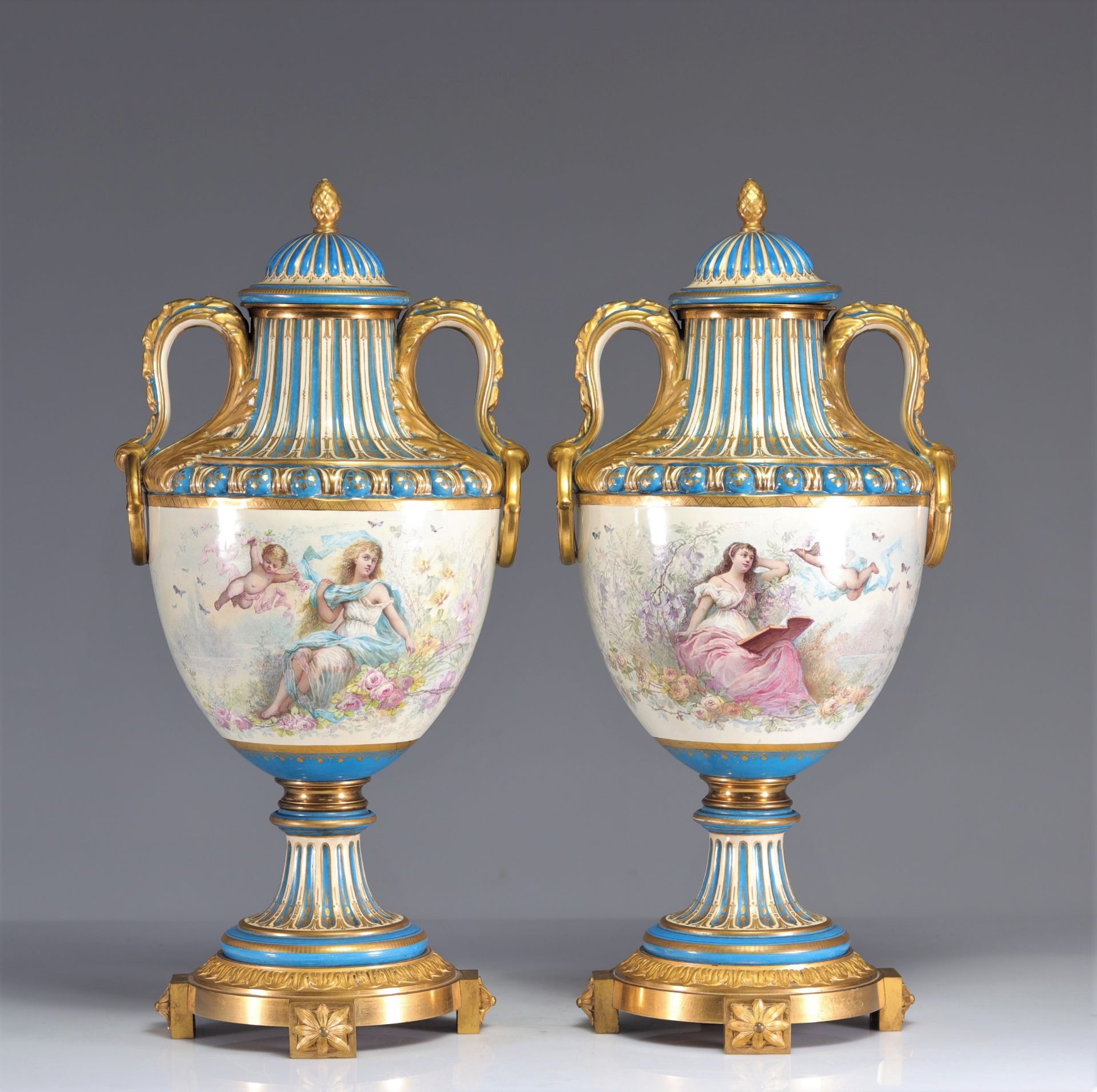 Sevres imposing pair of vases decorated with romantic scenes and cupids in gilded bronze