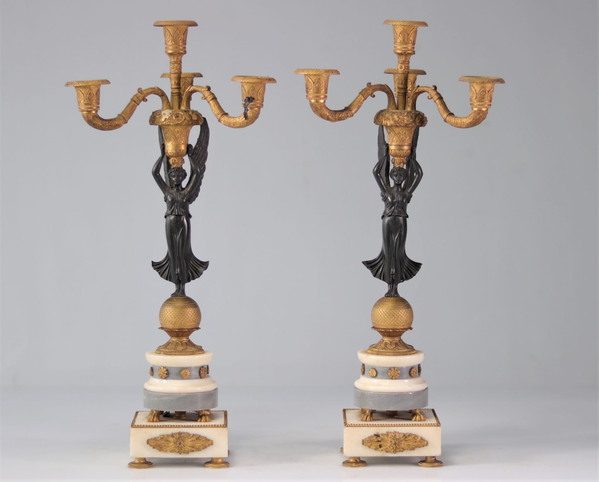 Pair of Empire candlesticks "winged women carrying fruit baskets"